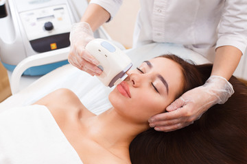 a woman receiving laser treatment on her face