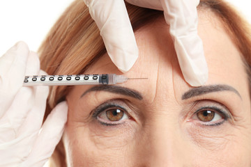 a woman receiving Botox treatment on her forehead
