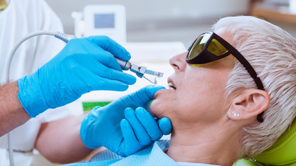 a woman receiving facial fillers treatment on her face
