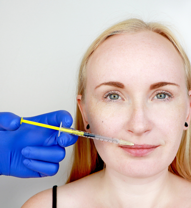 Woman having lip fillers injected