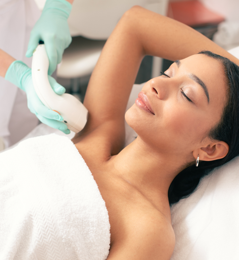 Woman undergoing laser hair removal on her underarms