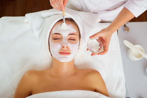 Woman with spa facials in salon.